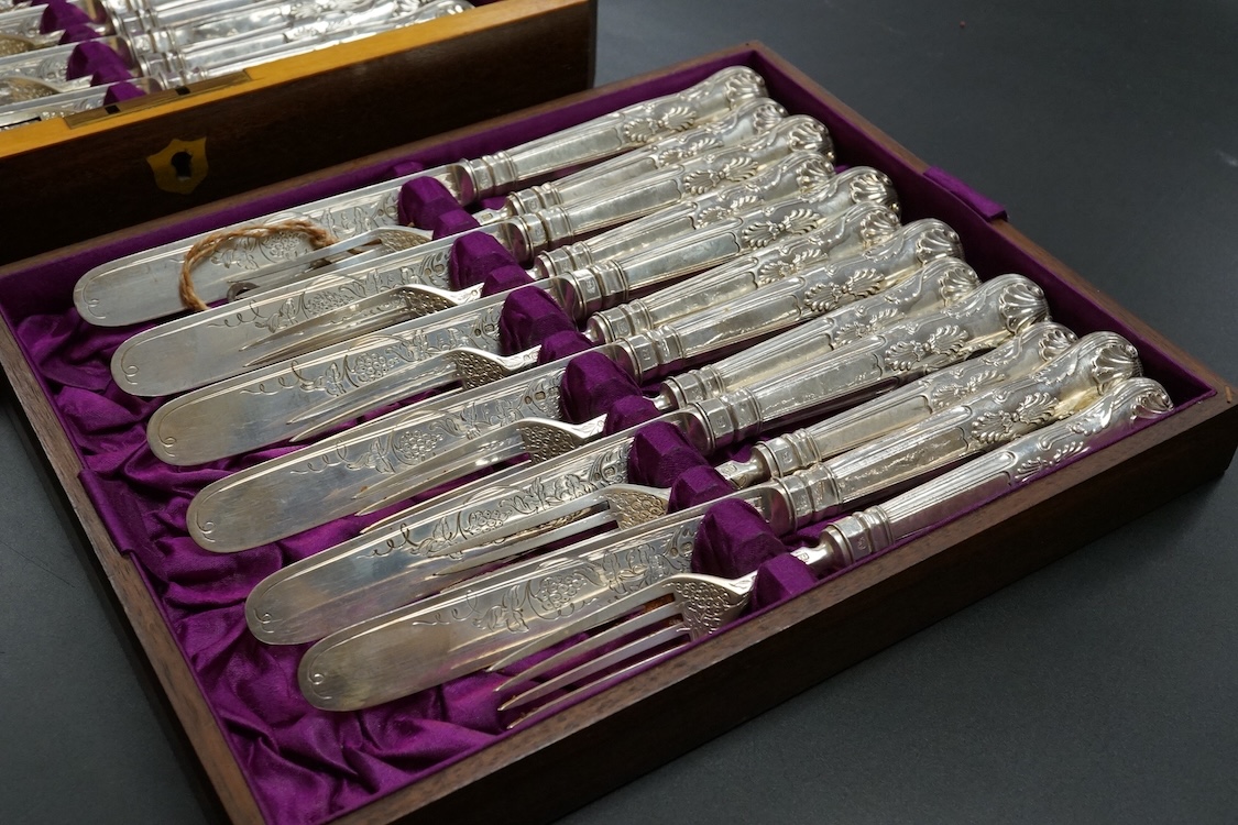 Twelve pairs of Victorian silver King's pattern dessert eaters, by John Gilbert, Birmingham, 1879/1880, loaded handles, in a mahogany canteen.